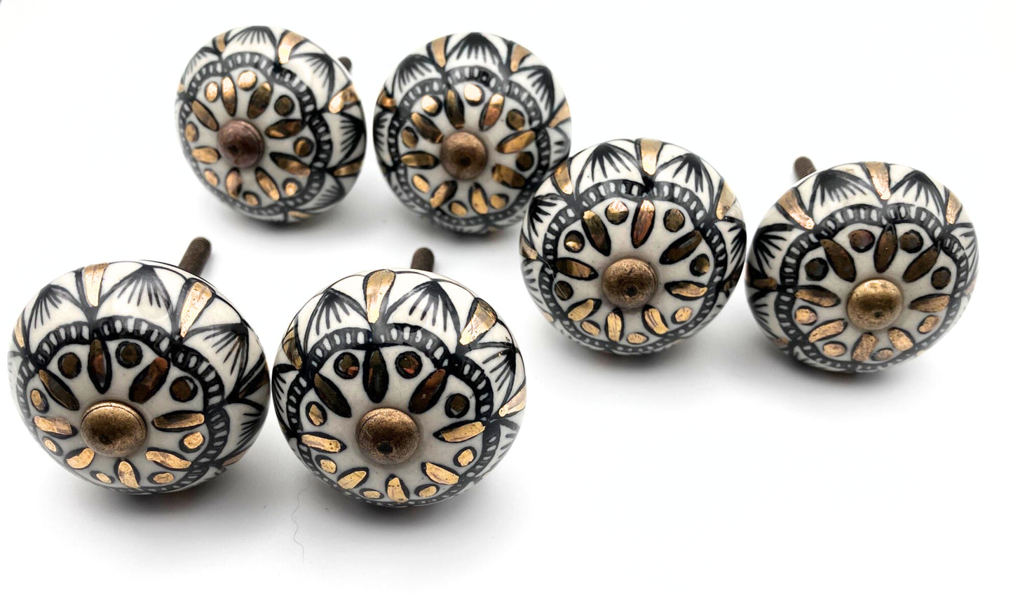 Set of decorative cabinet knobs with intricate patterns on a white background