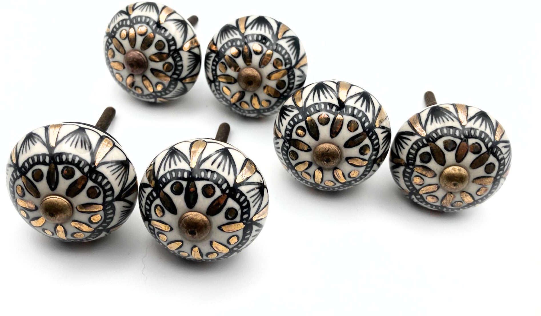 Set of decorative cabinet knobs with intricate patterns on a white background