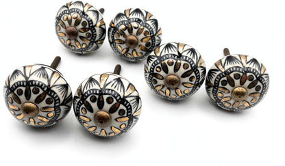 Set of decorative cabinet knobs with intricate patterns on a white background