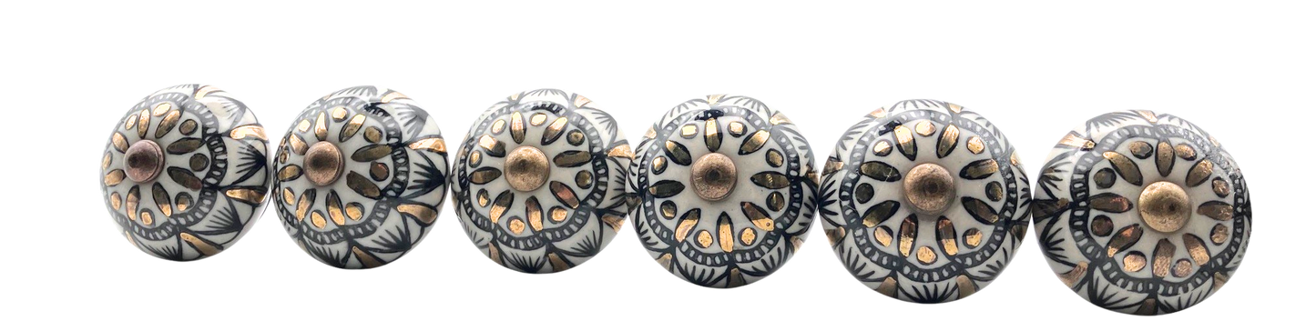 Set of decorative metal knobs with intricate designs on a white background