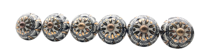 Set of decorative metal knobs with intricate designs on a white background