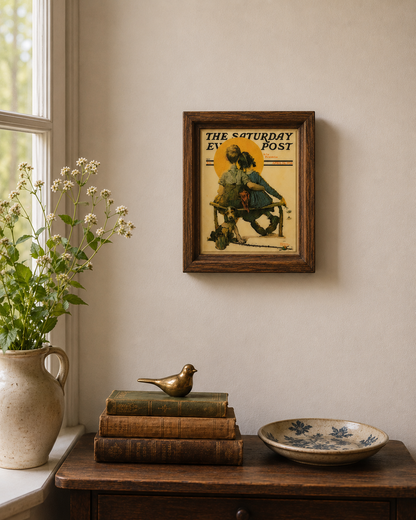 Vintage Saturday Evening Post cover artwork professionally framed and displayed above a rustic console table.