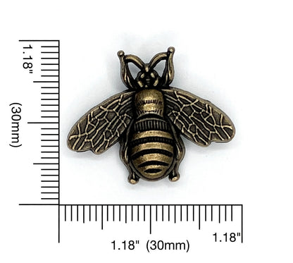 Bronze bee knob with measurement scale on a white background