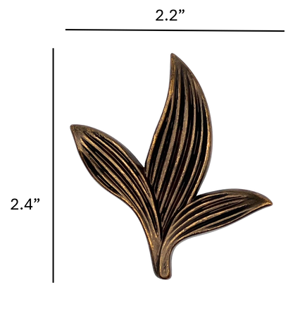 Bronze leaf-shaped decorative item with measurements on a white background