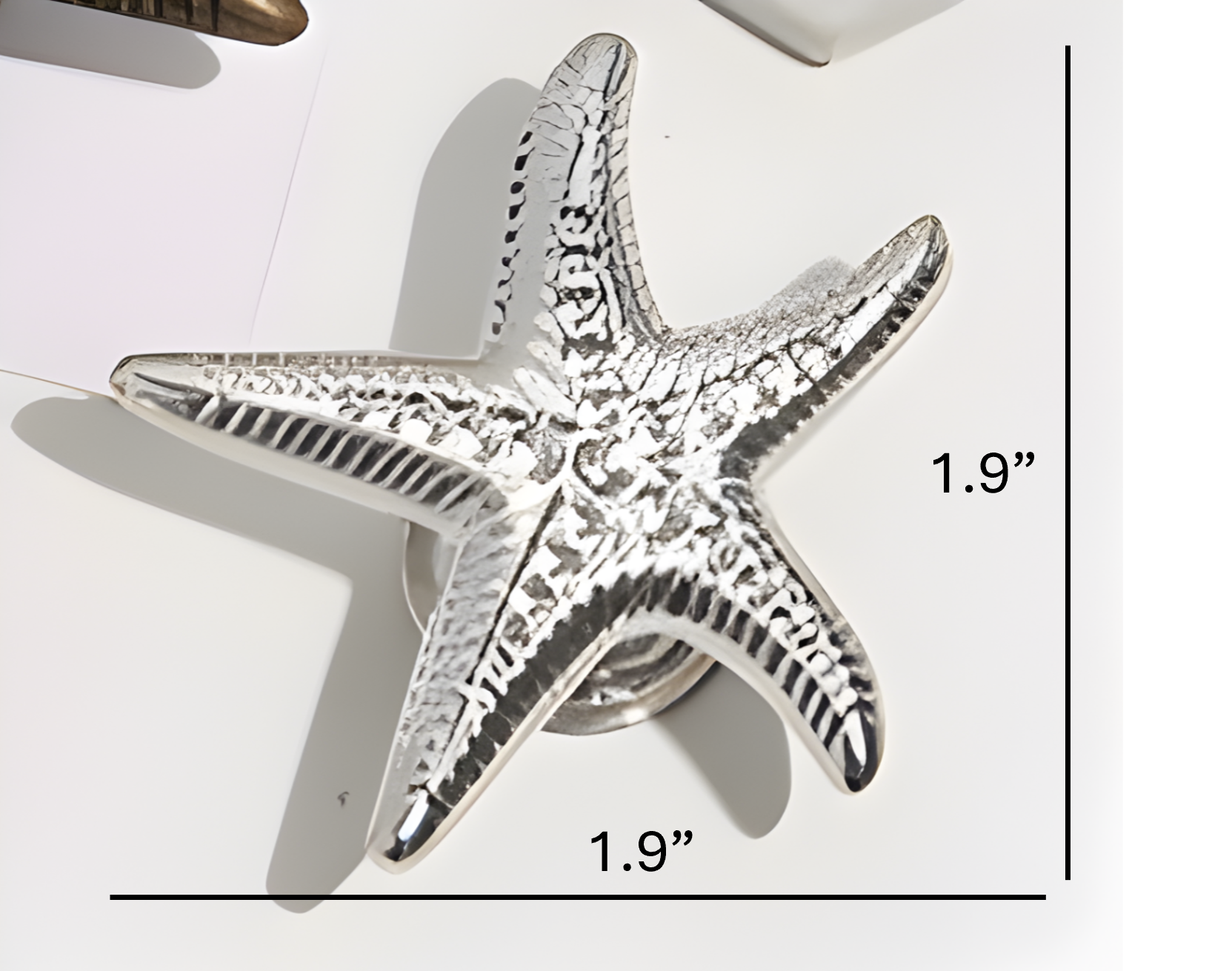Silver starfish knob with measurements on a white background