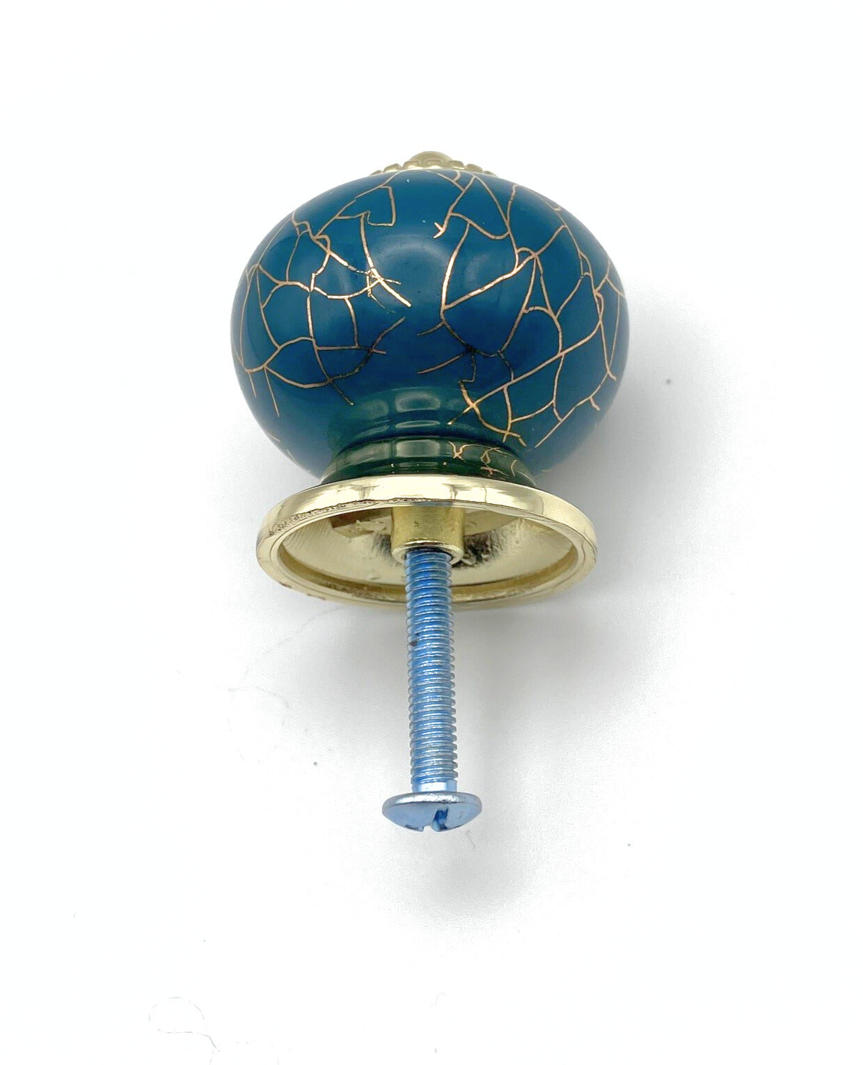 Blue Decorative knob with gold cracked accents and gold hardware on a white background