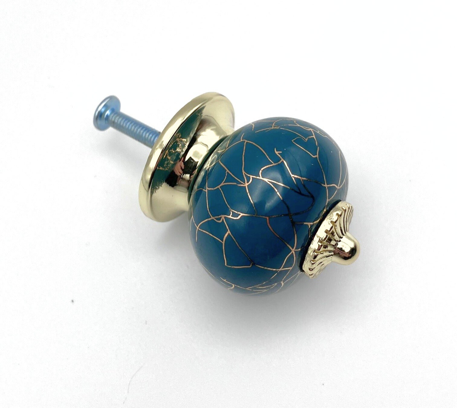 Decorative blue knob with gold accents on a white background