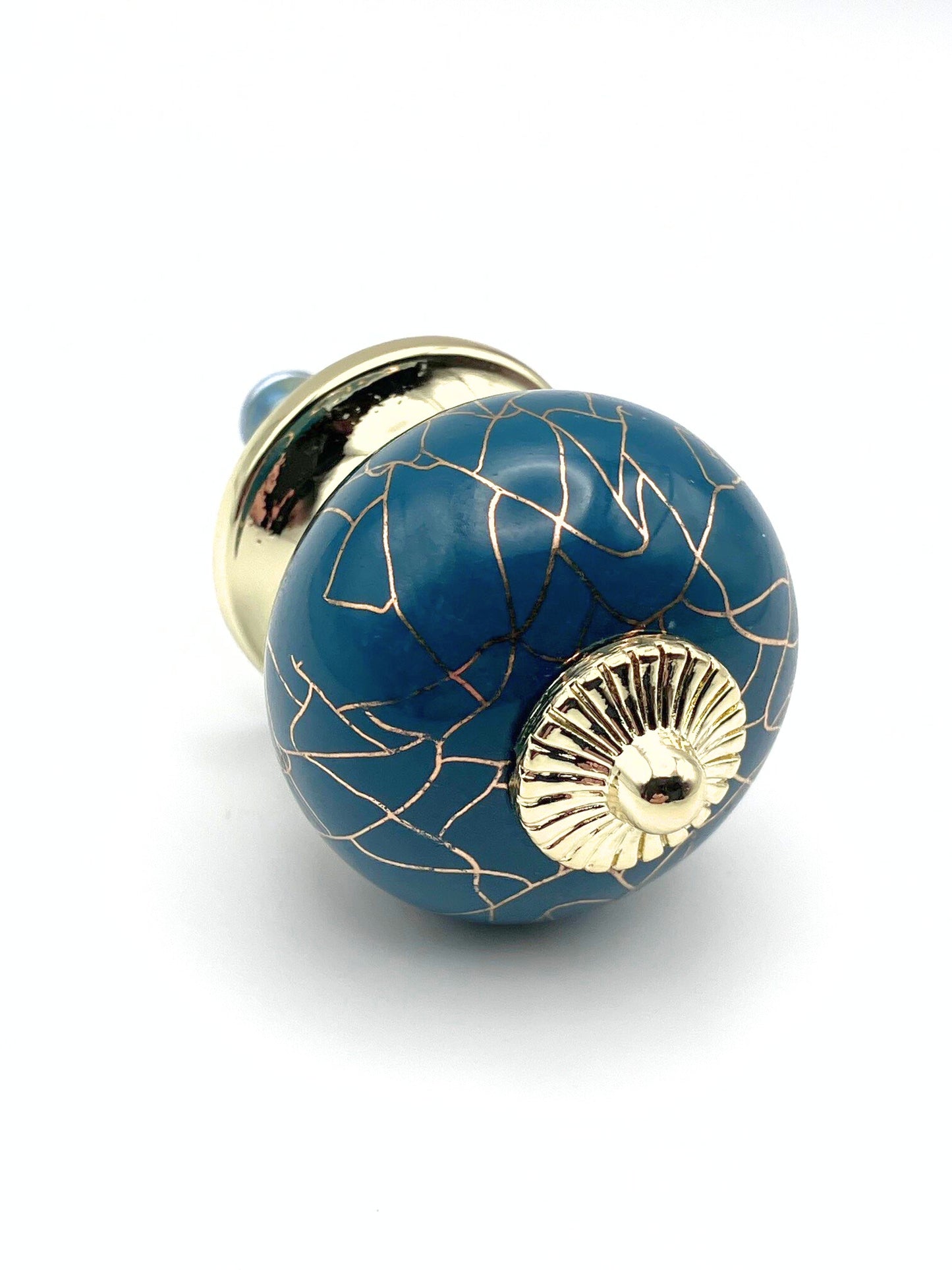 Blue ceramic knob with gold accents on a white background