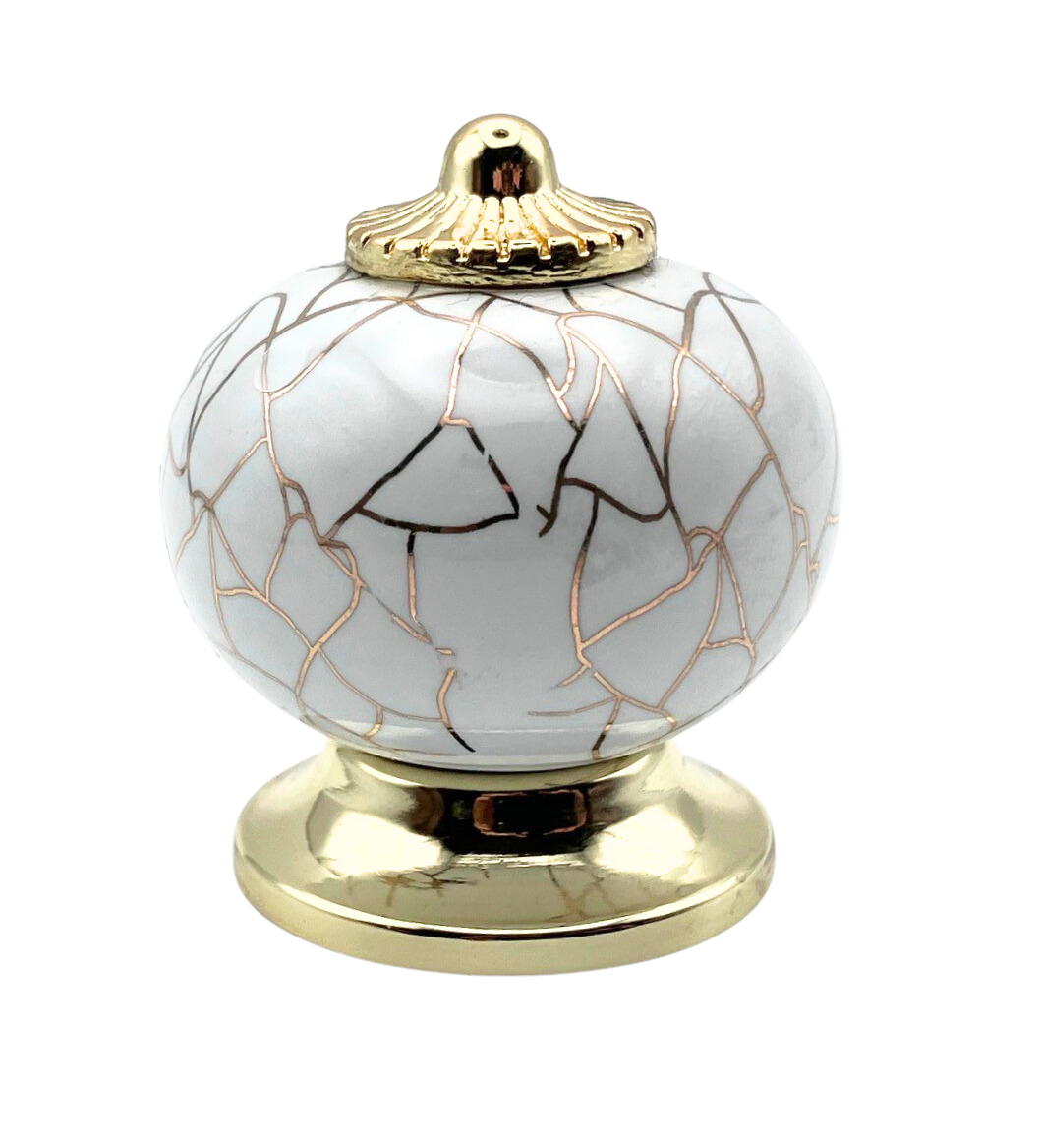 white round shaped knob with rose gold crackle design and gold metal hardware