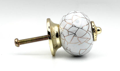 white round shaped knob with rose gold crackle design and gold metal hardware