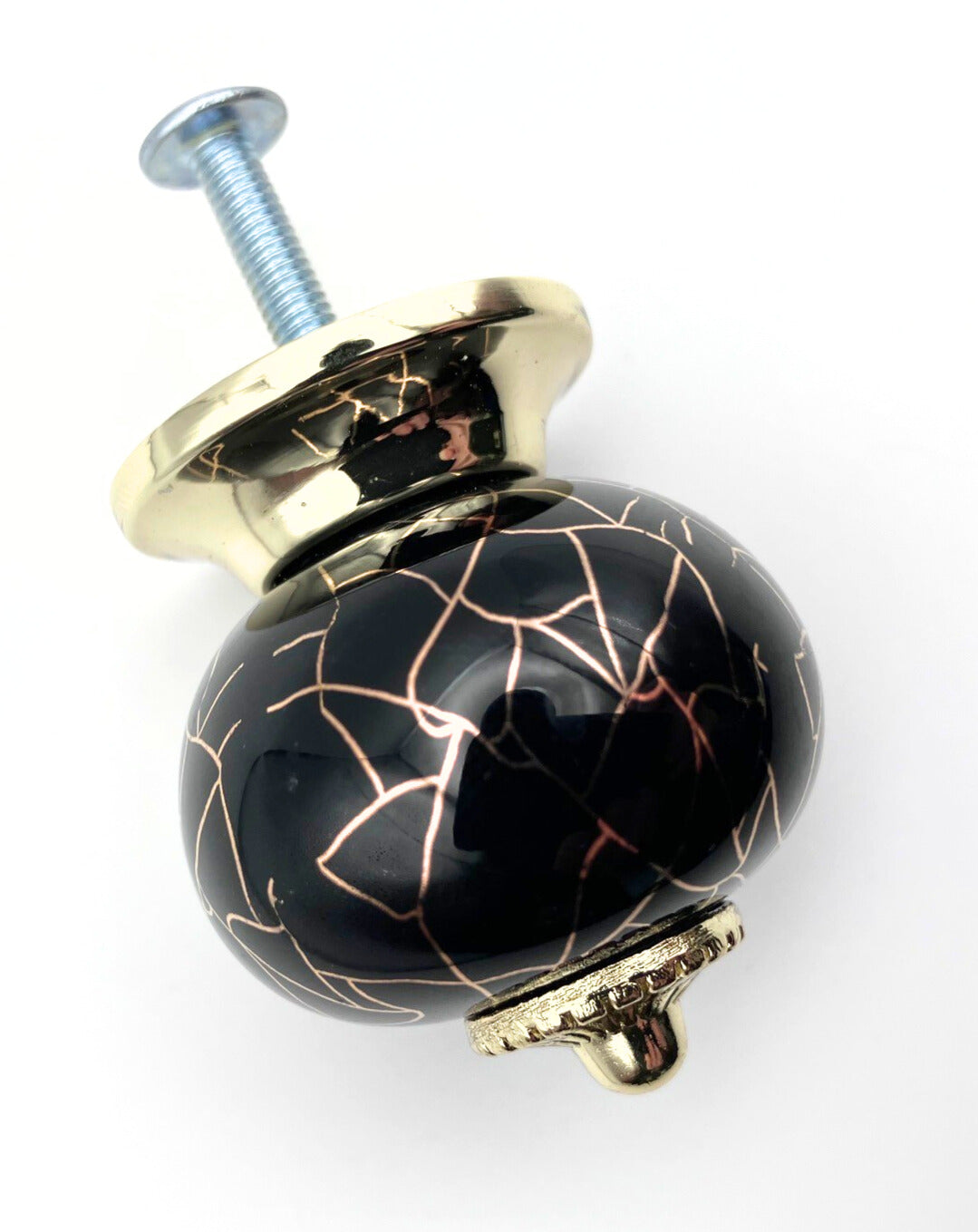 Decorative knob with black and gold design on a white background