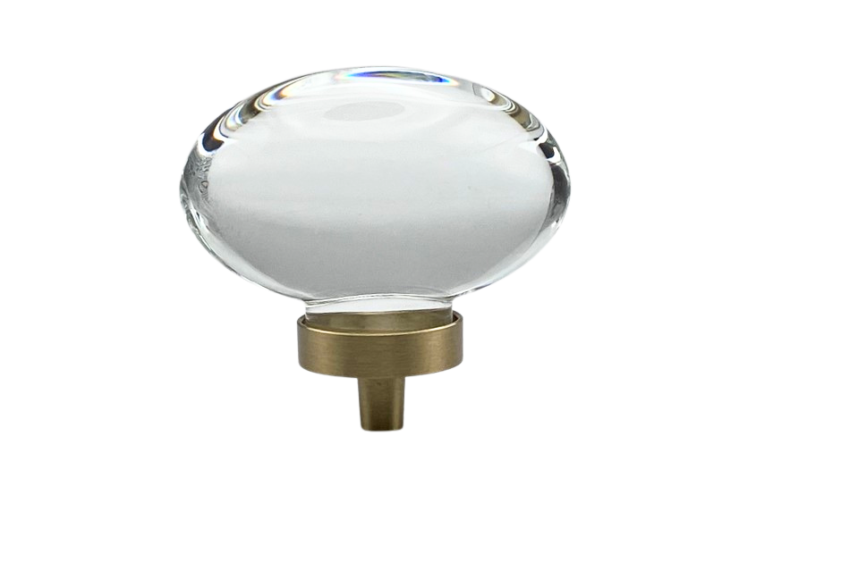 Clear oval knob with gold hardware on a white background