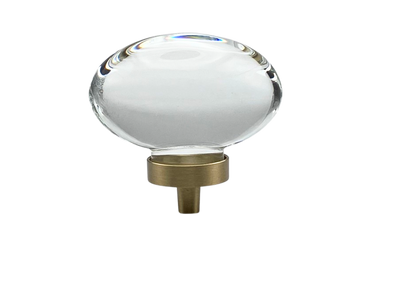 Clear oval knob with gold hardware on a white background