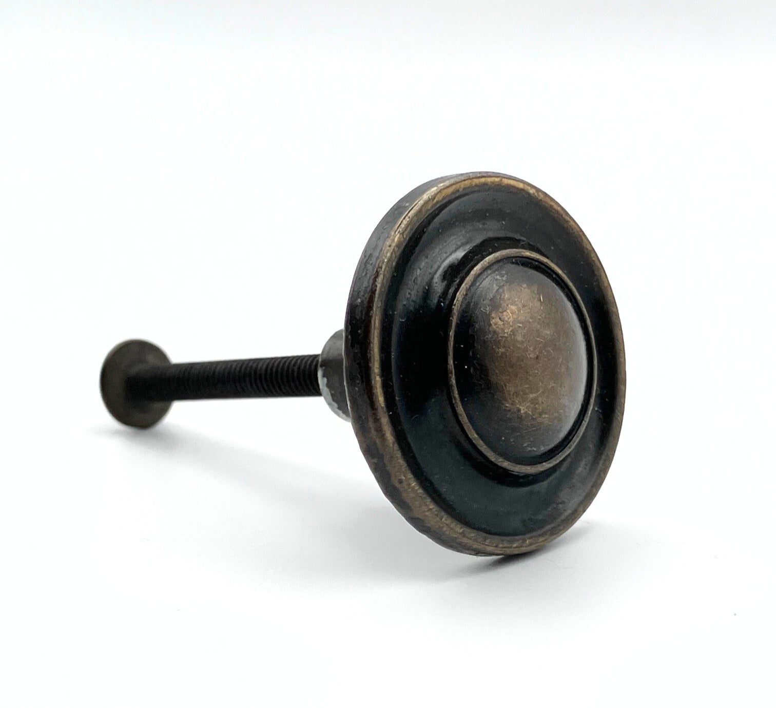 Decorative cabinet knob with black and bronze finish on a white background