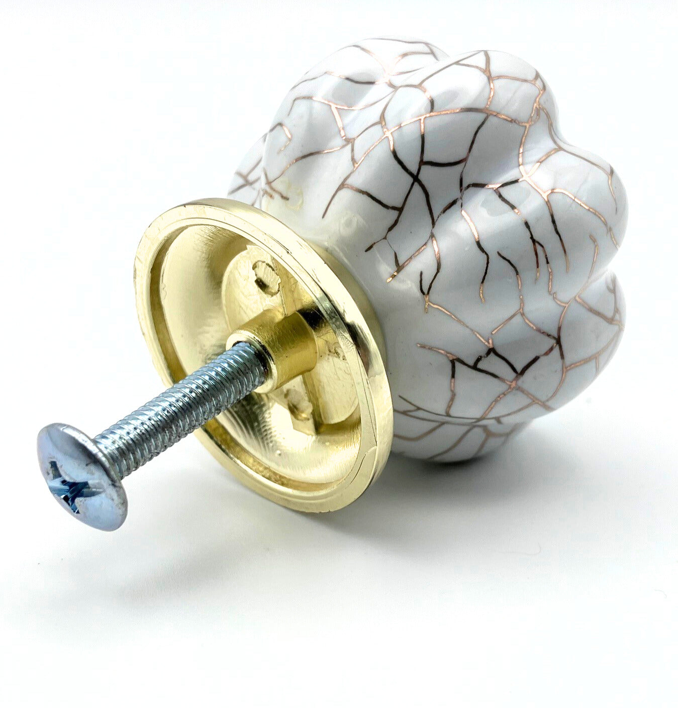 white pumpkin shaped knob with rose gold crackle design and gold metal hardware