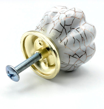 white pumpkin shaped knob with rose gold crackle design and gold metal hardware