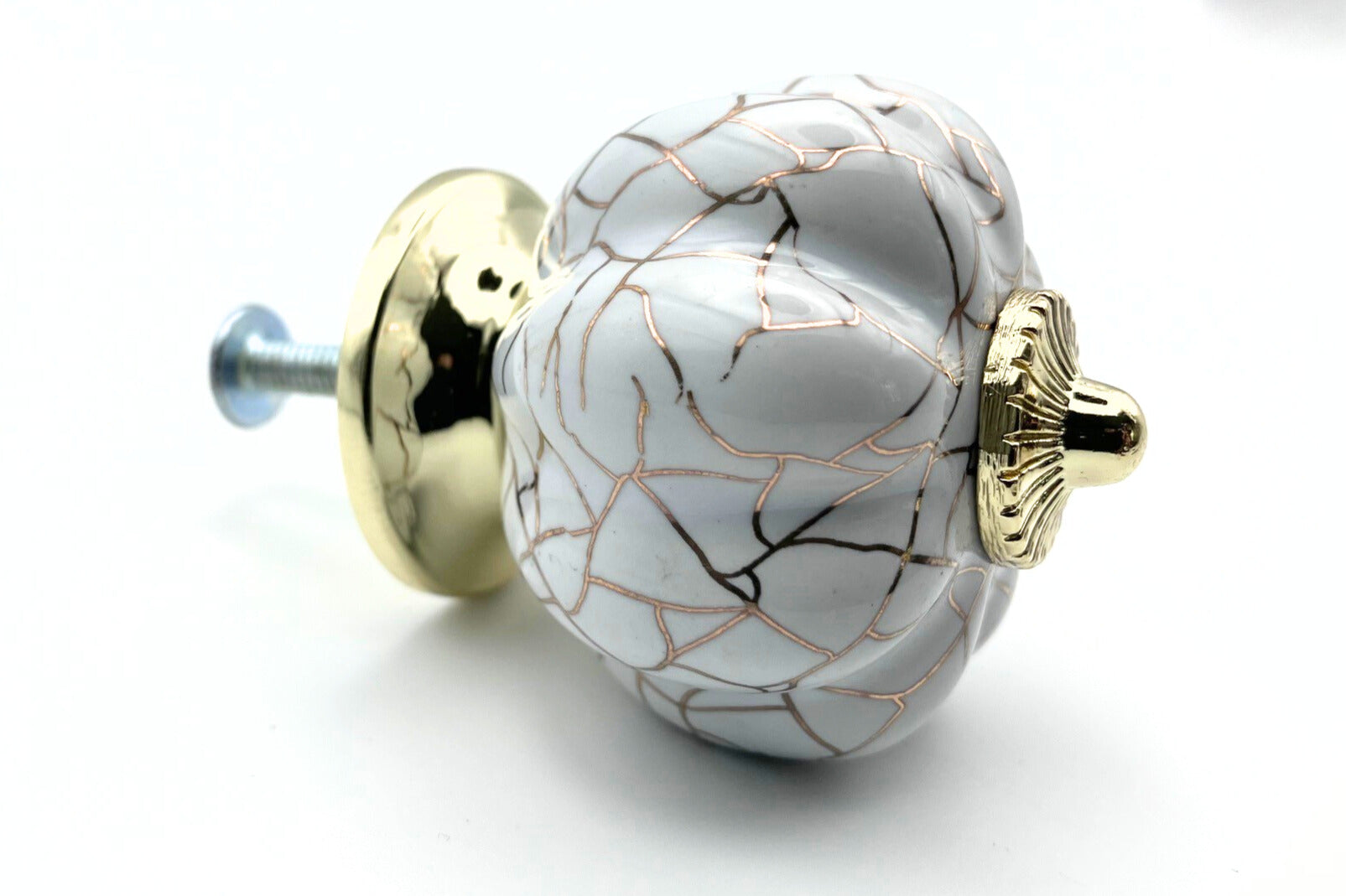 white pumpkin shaped knob with rose gold crackle design and gold metal hardware