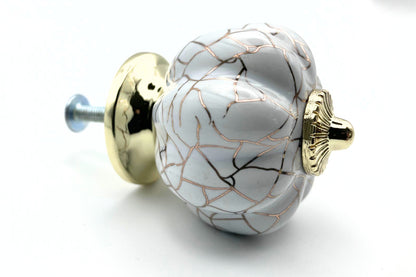 white pumpkin shaped knob with rose gold crackle design and gold metal hardware