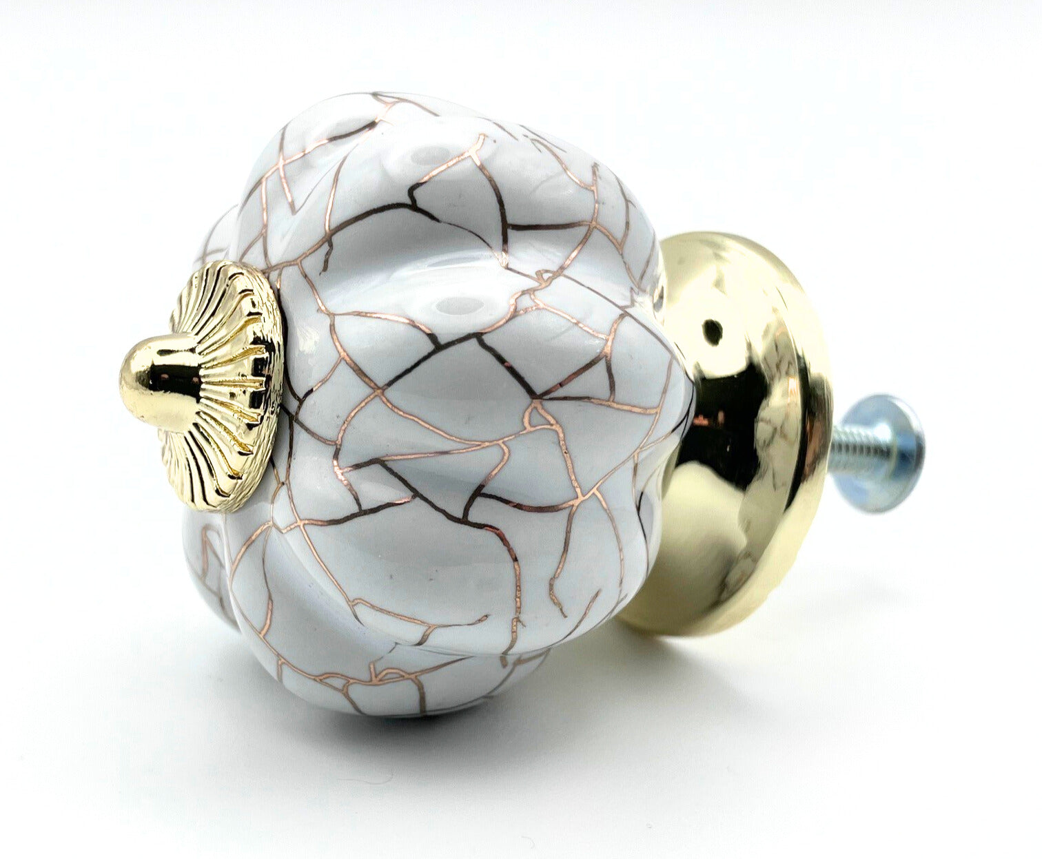 Decorative knob with marble pattern and gold accents on a white background