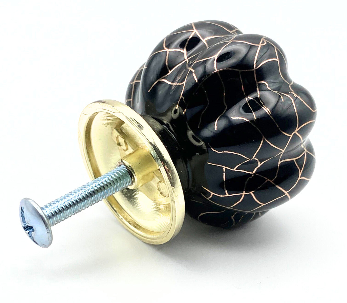Black and gold decorative cabinet knob on a white background