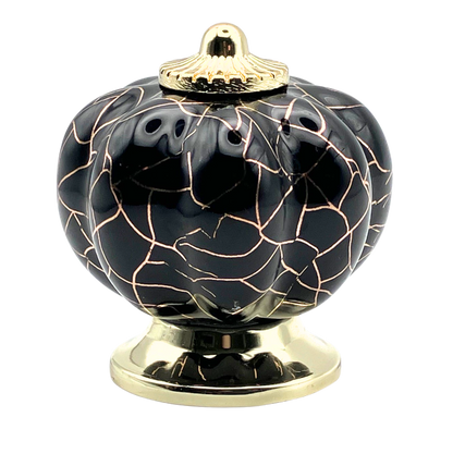 black pumpkin shaped knob with rose gold crackle design and gold metal hardware