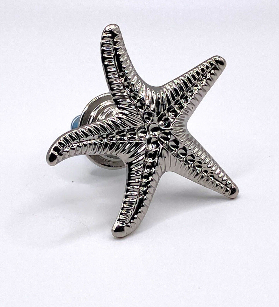 Silver starfish with hardware on white background