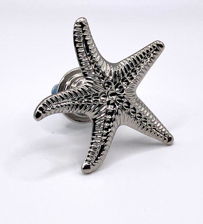 Silver starfish with hardware on white background