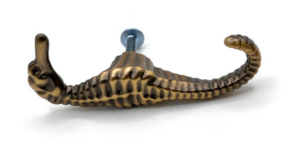 Bronze seahorse-shaped knob on a white background