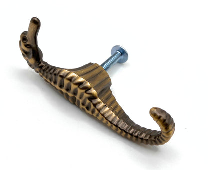 Bronze seahorse-shaped knob on a white background