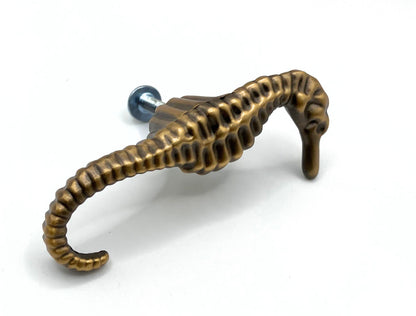 Bronze seahorse-shaped knob on a white background