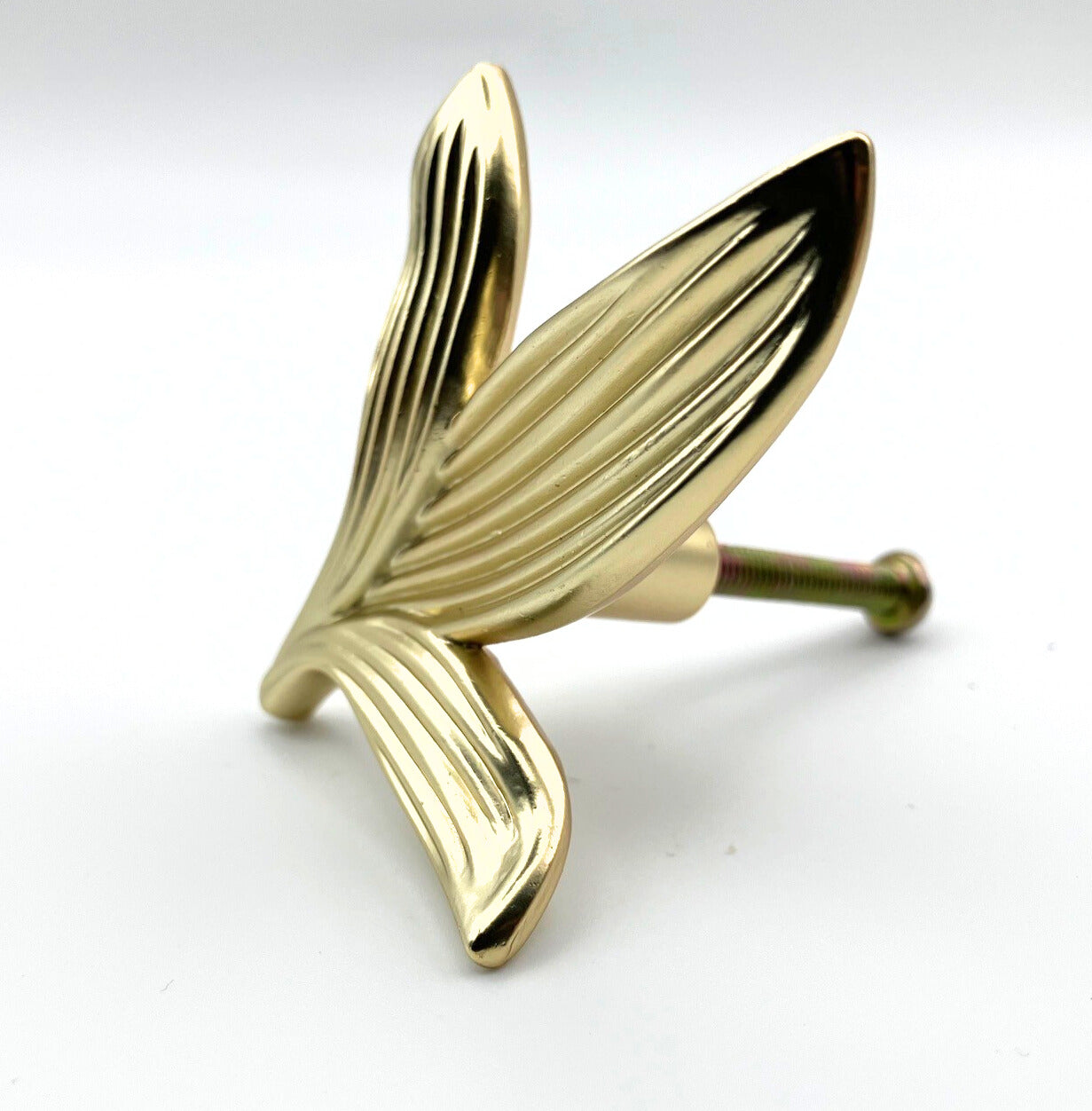 Gold leaf-shaped knob on a white background