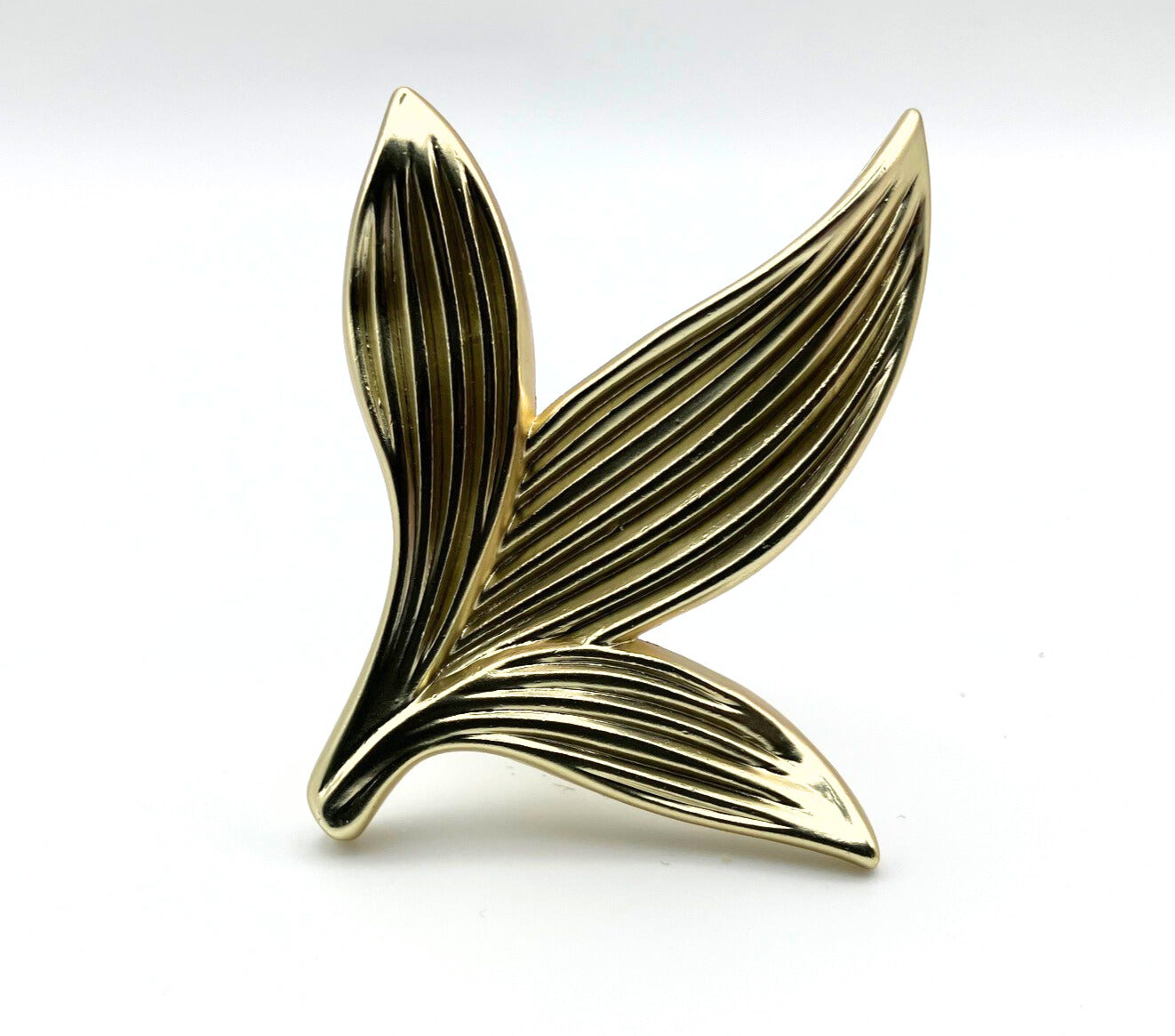 Gold leaf-shaped knob on a white background