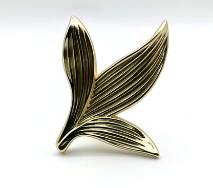Gold leaf-shaped knob on a white background