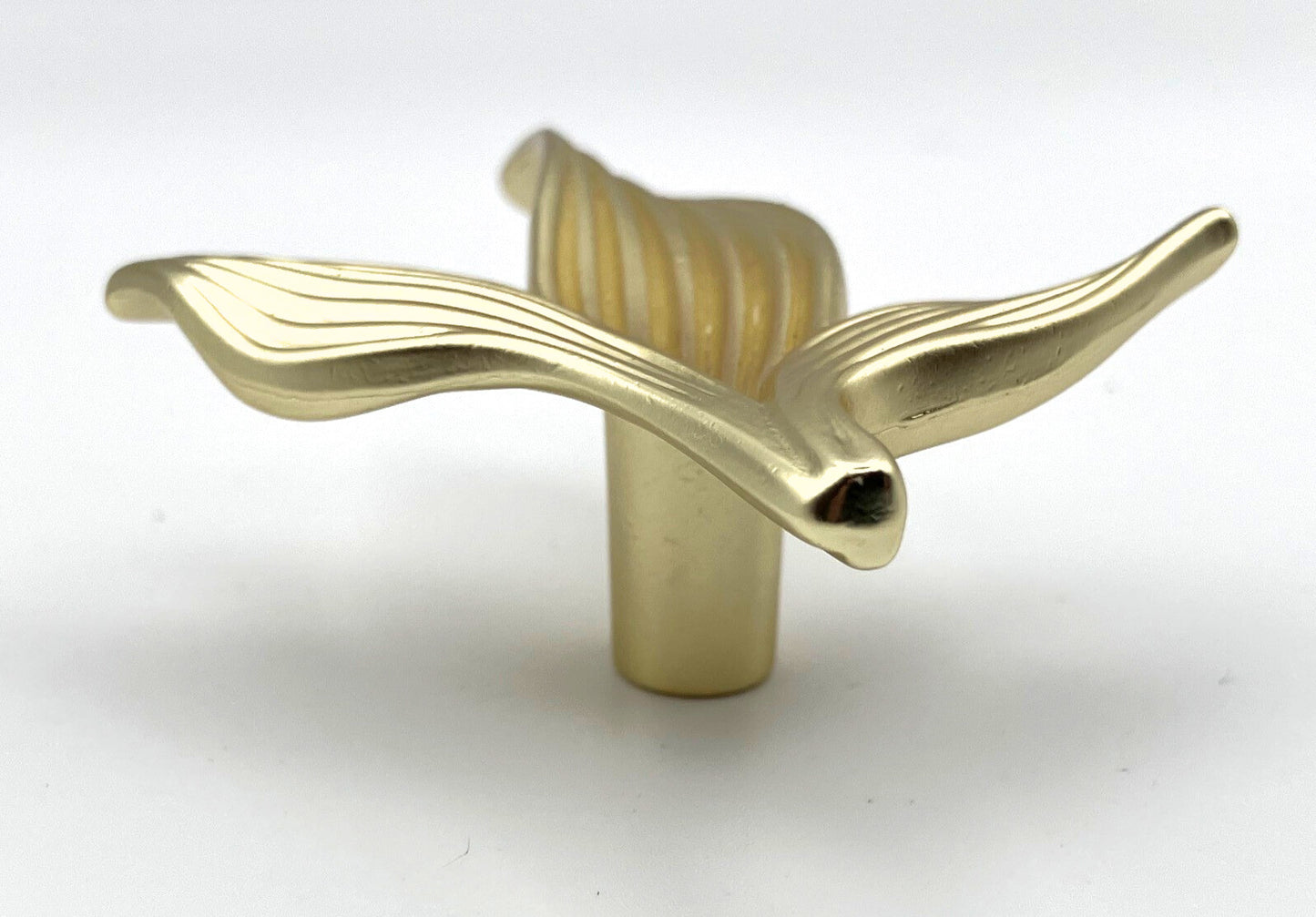 Gold leaf-shaped knob on a white background