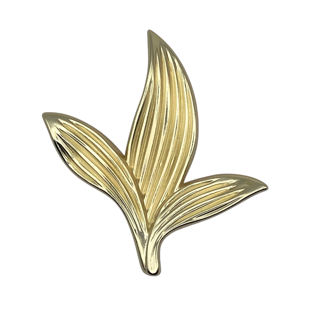 Gold leaf-shaped knob on a white background