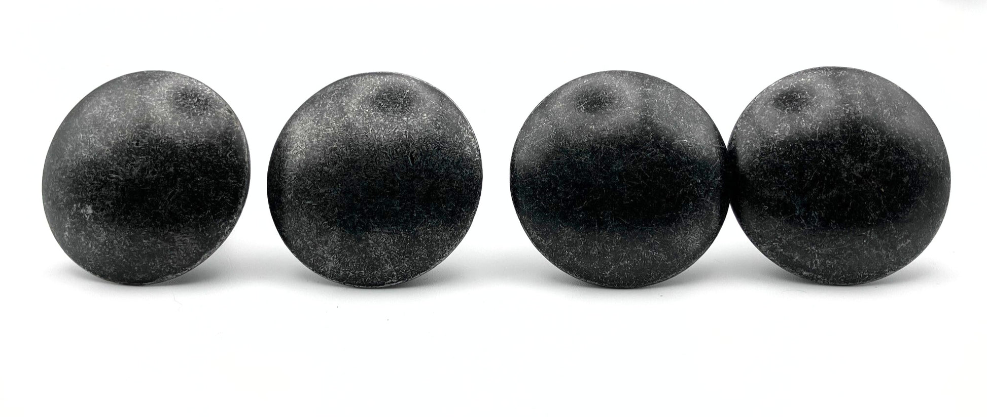 Four black knobs objects on a white background