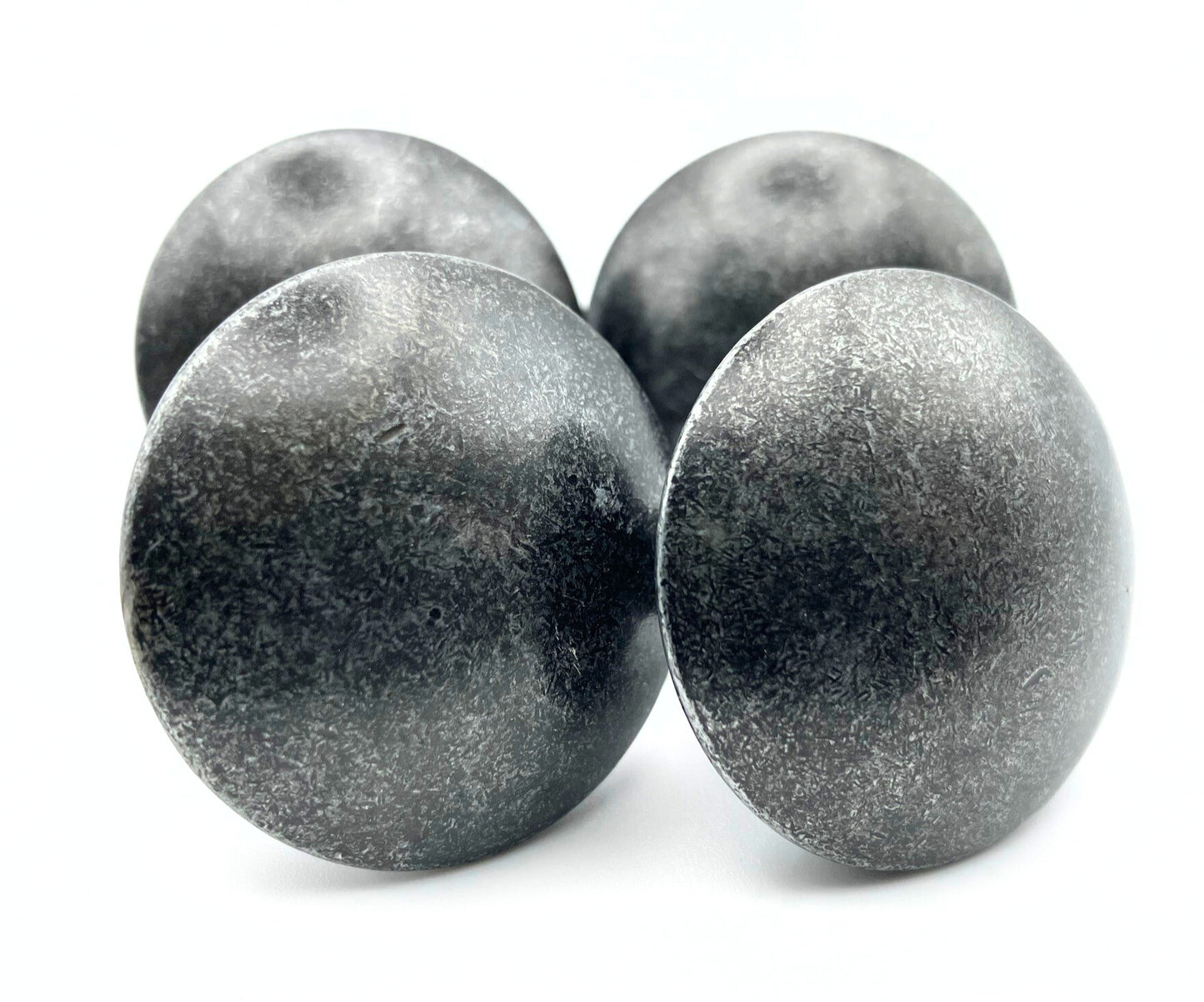 Four metallic knobs on a white background