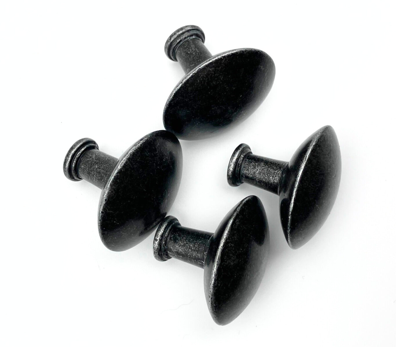 Four black metal cabinet knobs on a white background