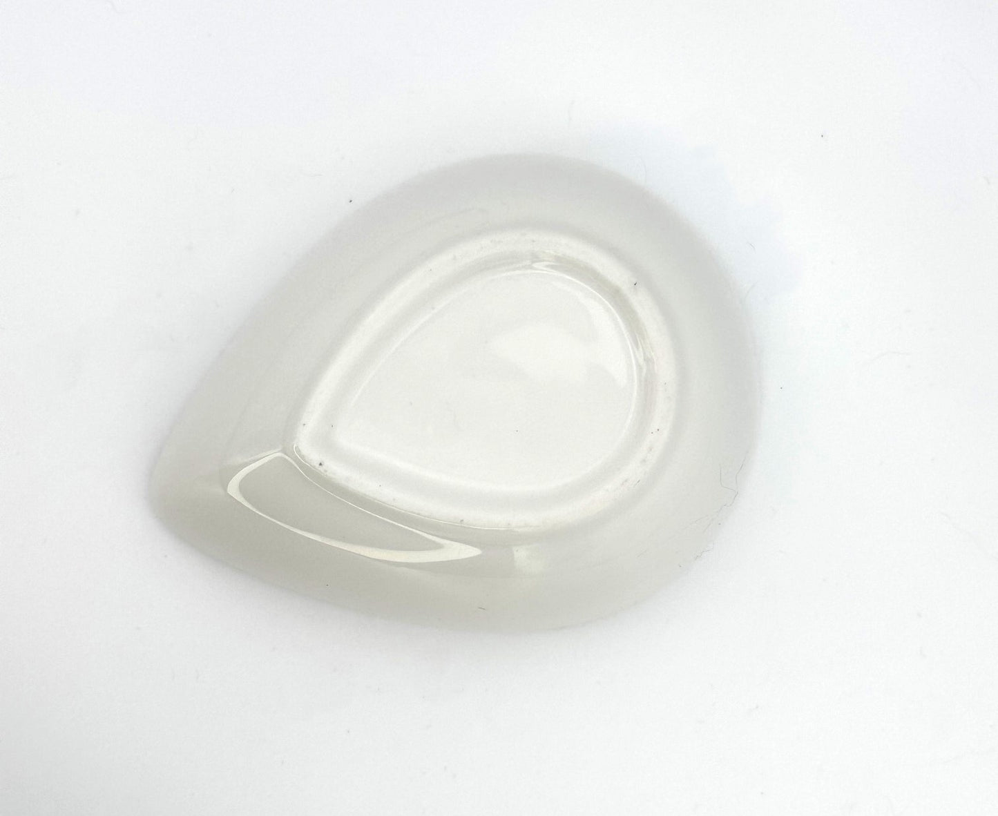 Artisan ceramic teardrop bowl with warm orange interior for display or tabletop décor
