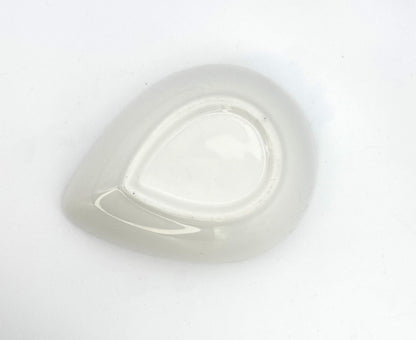 Artisan ceramic teardrop bowl with warm orange interior for display or tabletop décor