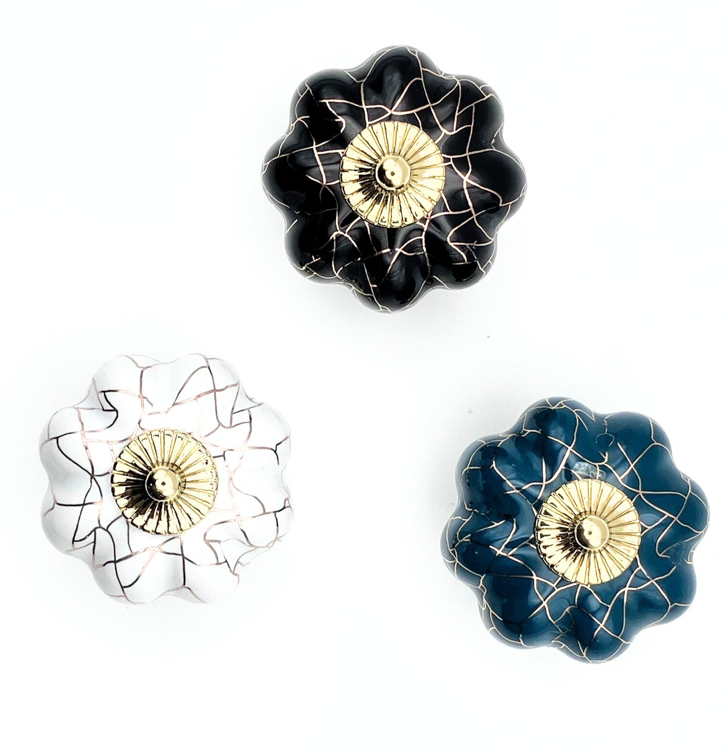 Set of three decorative knobs with crackle designs on a white background