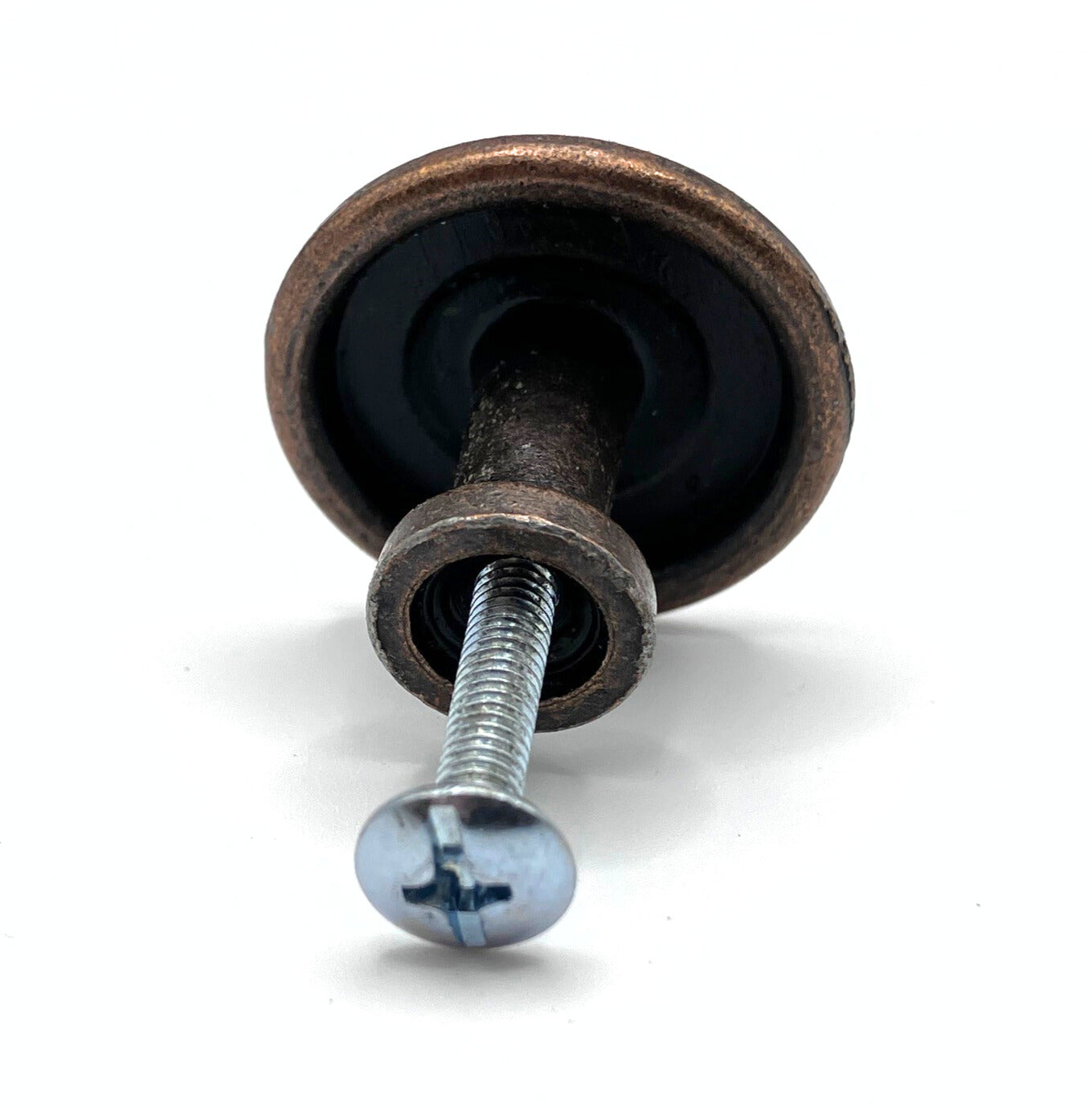 Decorative metal knob with floral design on a white background