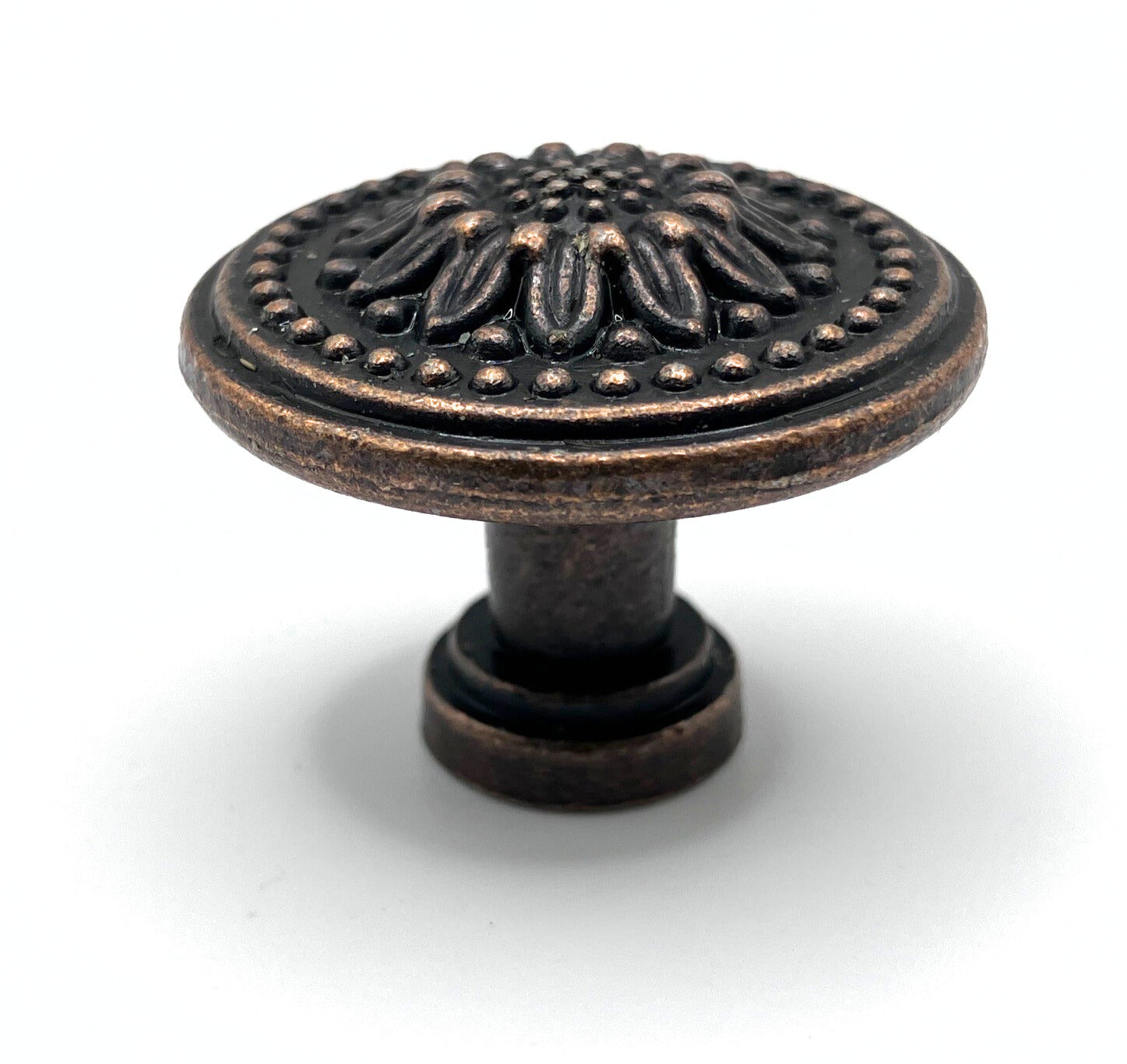 Decorative cabinet knob with intricate design on a white background