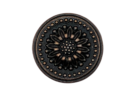 Decorative metal knob with floral design on a white background