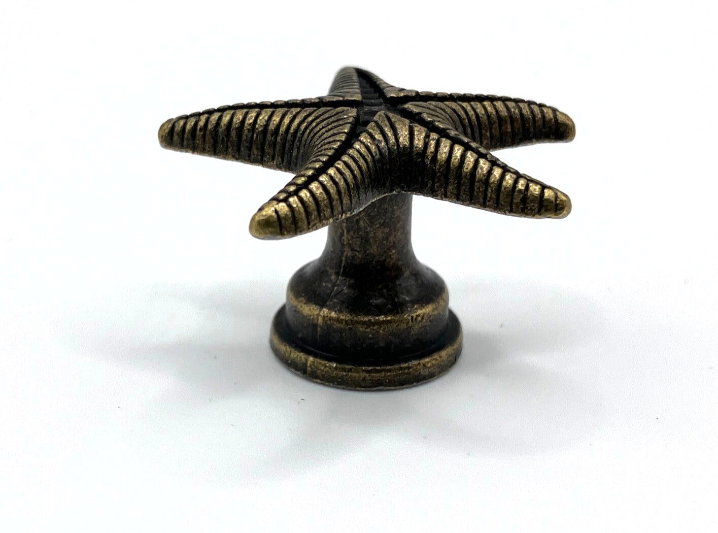 Bronze starfish-shaped knob on a white background