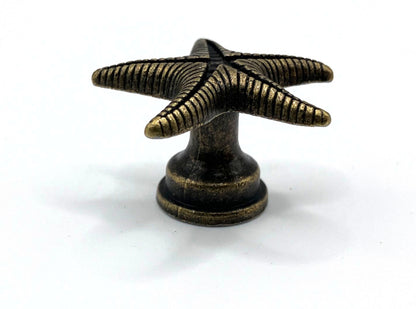 Bronze starfish-shaped knob on a white background