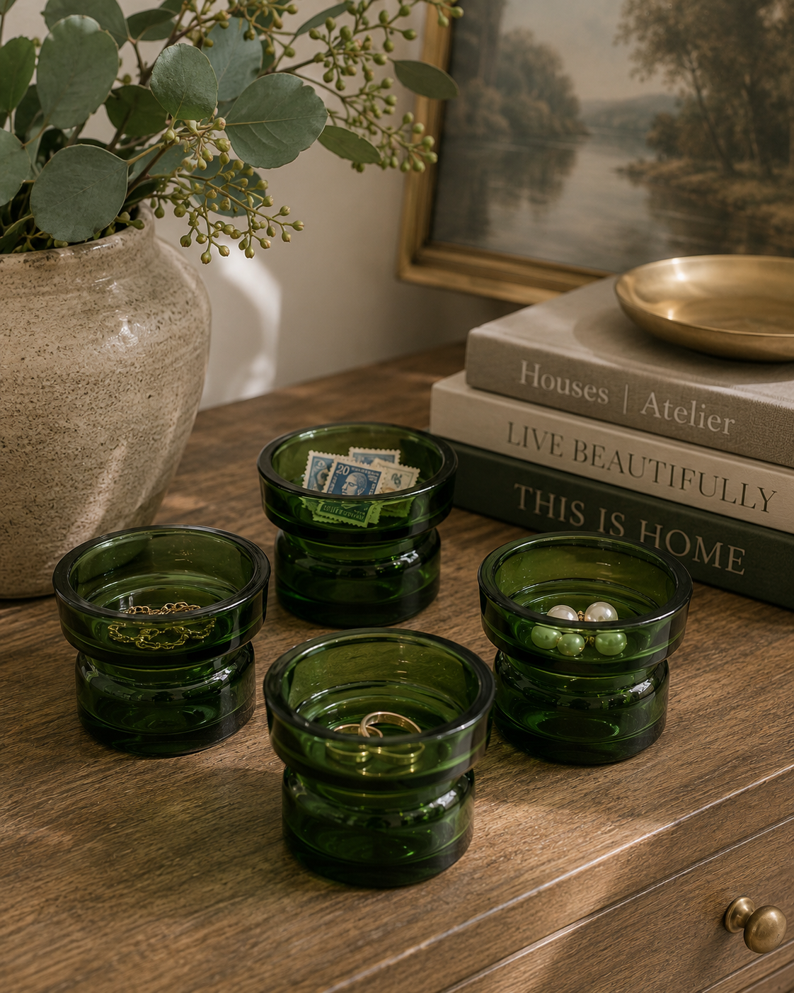 Vintage green Dansk glass holders repurposed as bathroom organizers for cotton balls and small accessories.
