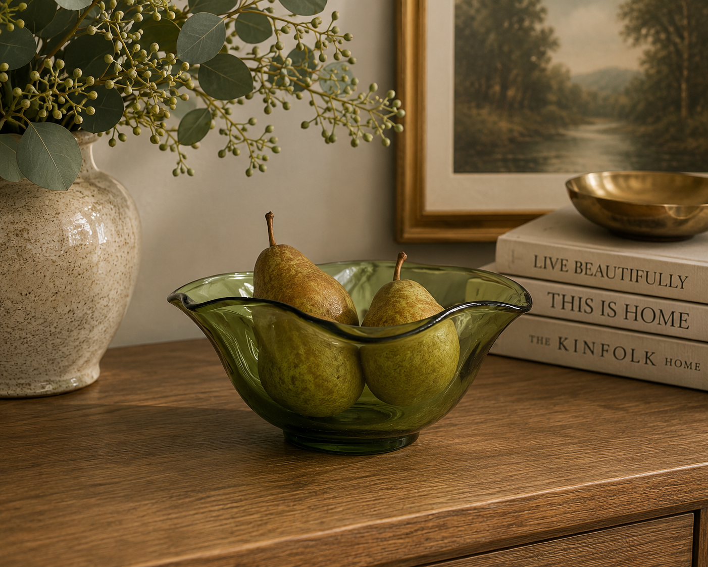 Vintage green wavy-edge glass bowl used as a dining table centerpiece filled with fresh citrus fruit.