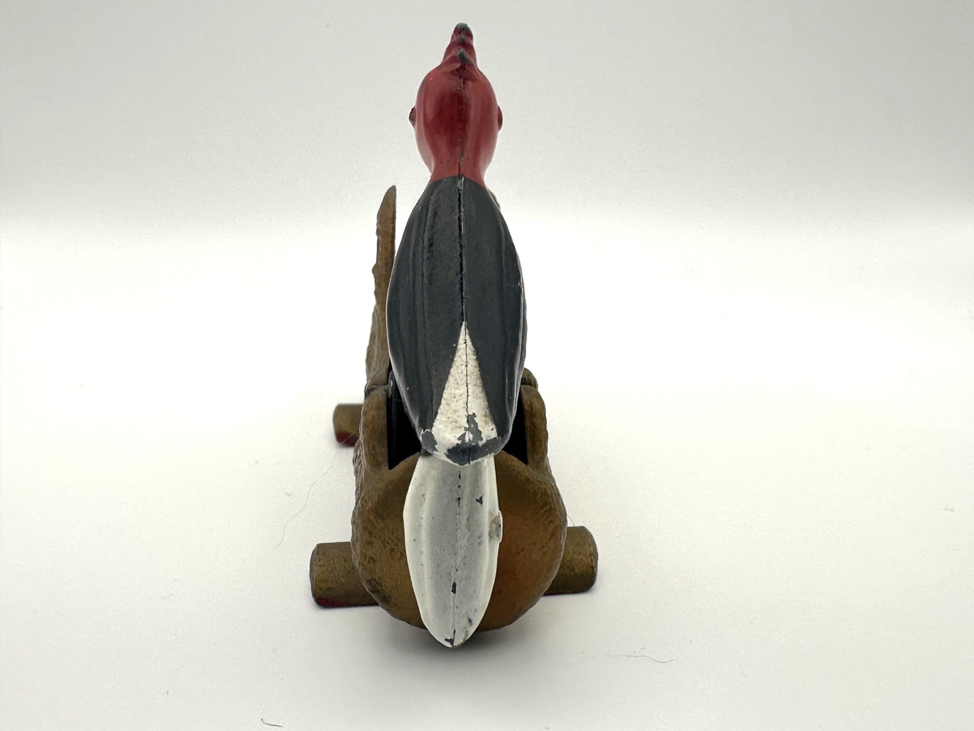 Vintage cast iron bird-shaped toothpick holder with woodpecker design and mechanical dispenser function
