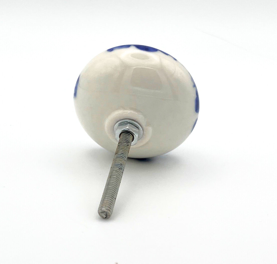 White ceramic knob with blue and red design on a white background